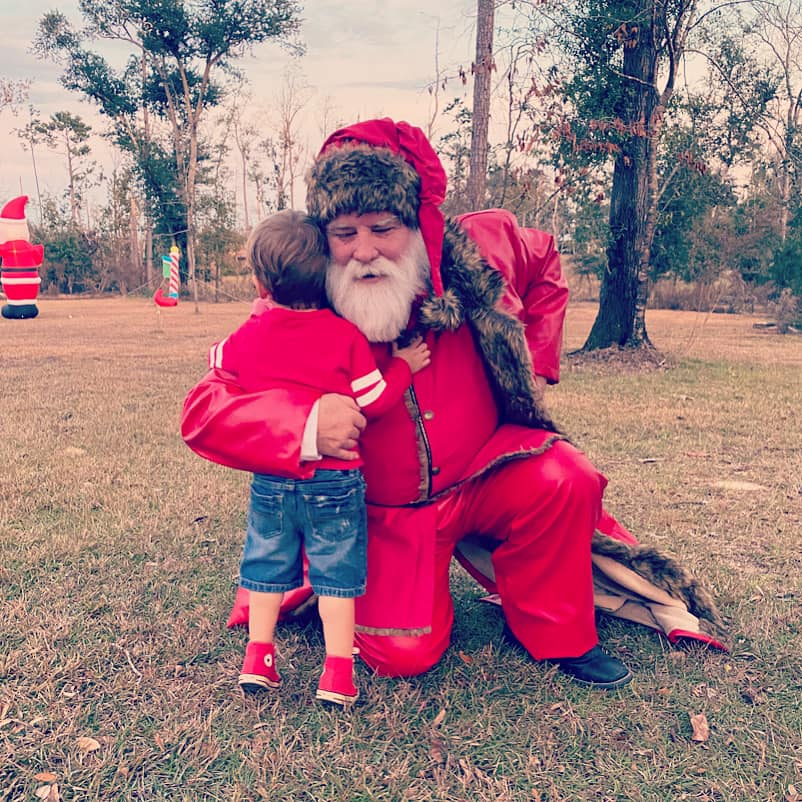 Santa hugging child