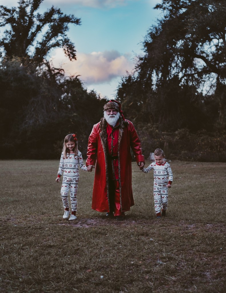 Santa holding hands with children